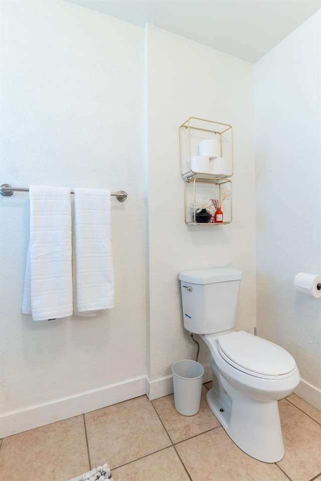 bathroom with tile patterned flooring and toilet