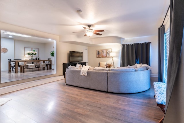 living room with ceiling fan and hardwood / wood-style floors