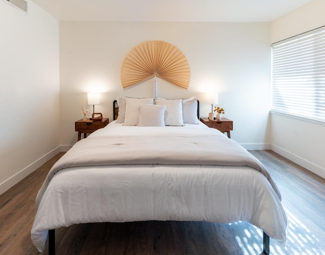 bedroom with dark wood-type flooring