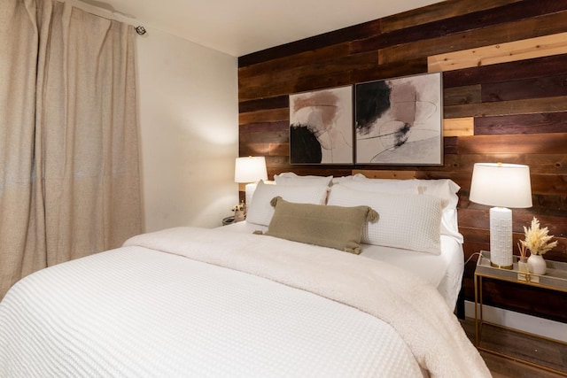 bedroom featuring wood walls