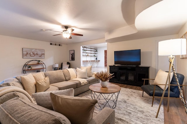 living room with hardwood / wood-style flooring and ceiling fan