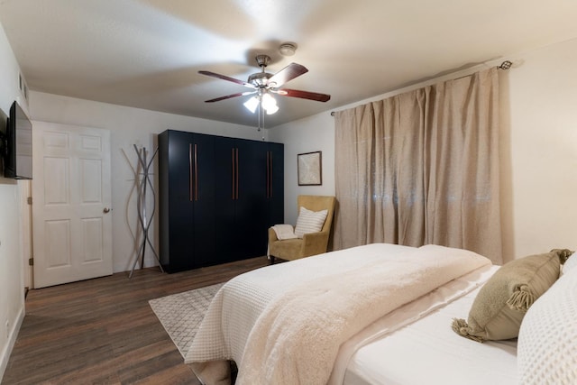 bedroom with ceiling fan and dark hardwood / wood-style flooring