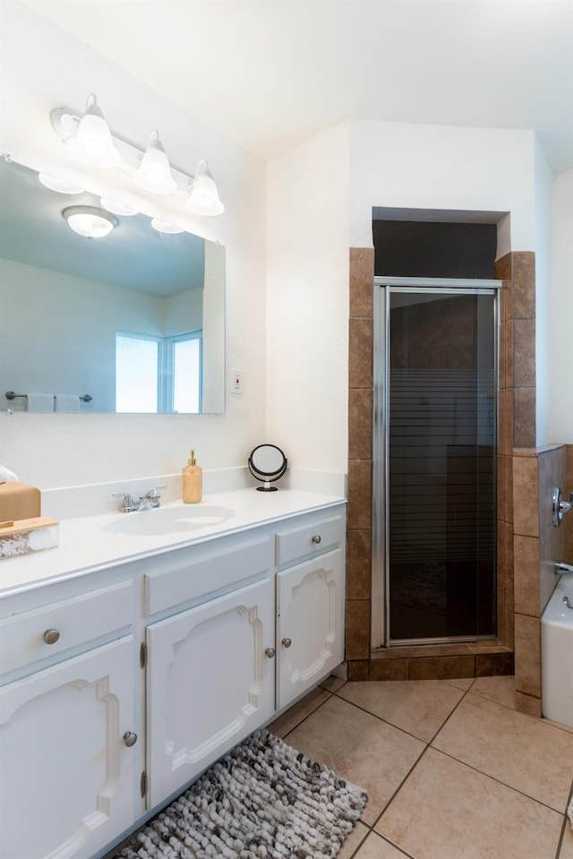 bathroom featuring tile patterned flooring, shower with separate bathtub, and vanity