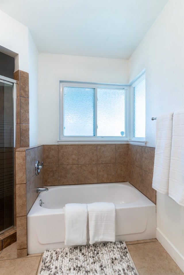 bathroom featuring tile patterned flooring and plus walk in shower