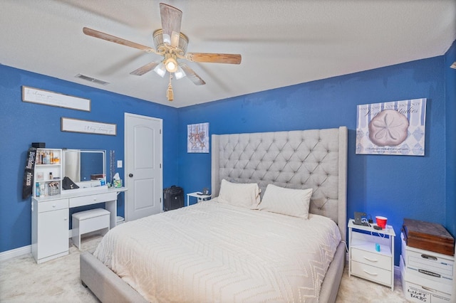 bedroom featuring a ceiling fan, baseboards, visible vents, and carpet flooring