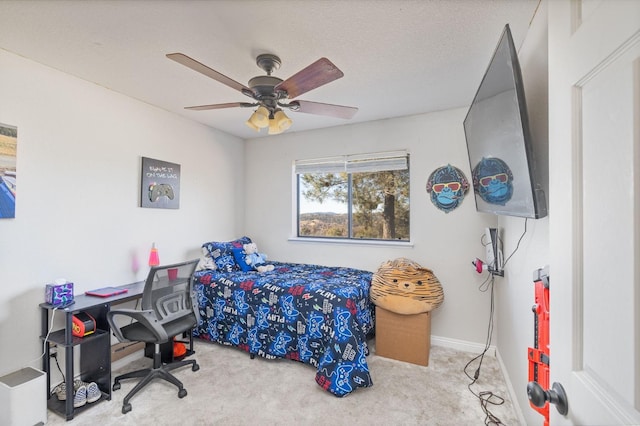 bedroom with carpet floors, ceiling fan, baseboards, and a textured ceiling