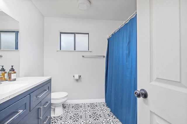 full bathroom featuring tile patterned flooring, baseboards, vanity, and toilet