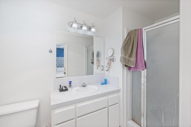 bathroom featuring backsplash, a shower stall, toilet, and vanity