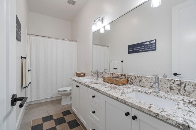 bathroom with toilet, a shower with shower curtain, vanity, and tile patterned flooring