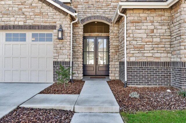 entrance to property featuring french doors and a garage