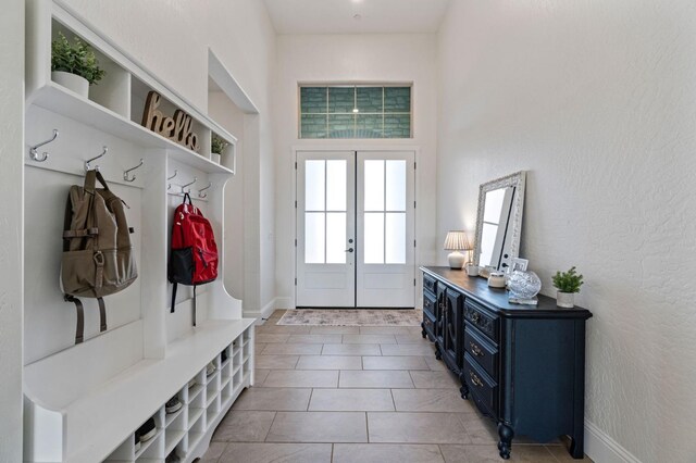 mudroom with french doors and light tile patterned floors