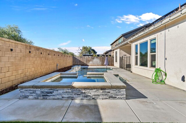 view of swimming pool with a patio and an in ground hot tub