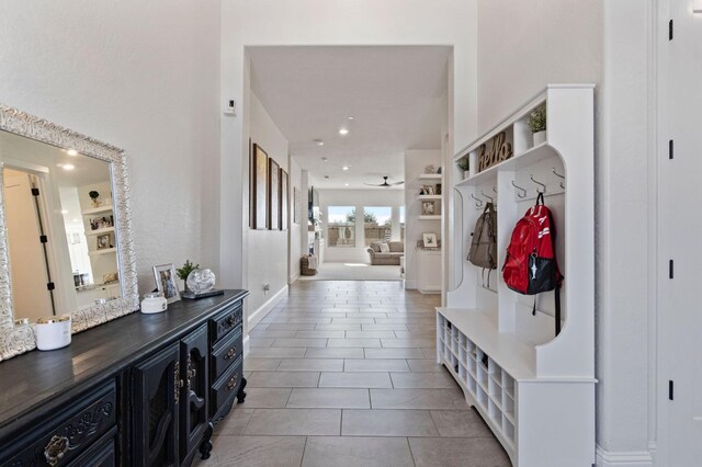 mudroom featuring ceiling fan and light tile patterned floors