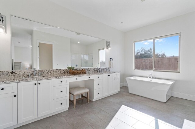 bathroom with independent shower and bath and vanity