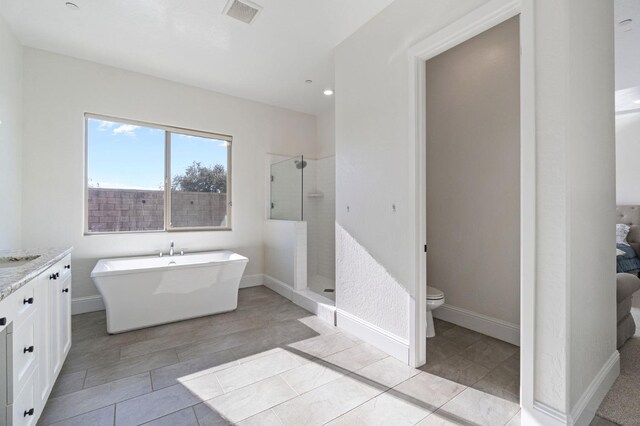 full bathroom with toilet, shower with separate bathtub, vanity, and tile patterned flooring