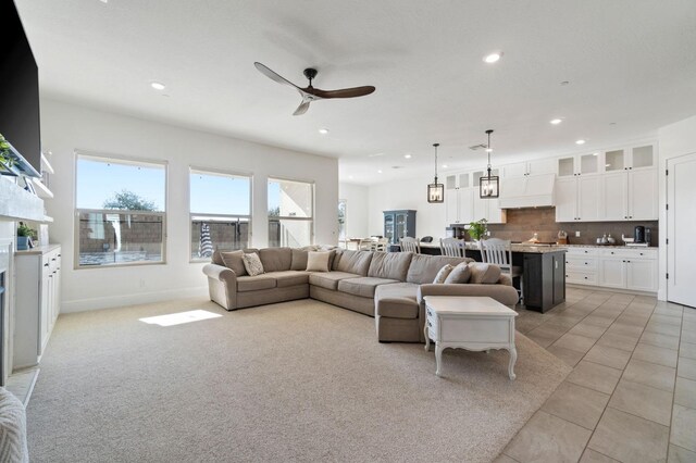 tiled living room featuring ceiling fan