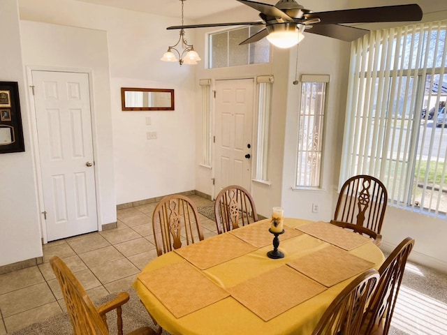 dining area with light tile patterned floors, plenty of natural light, and baseboards