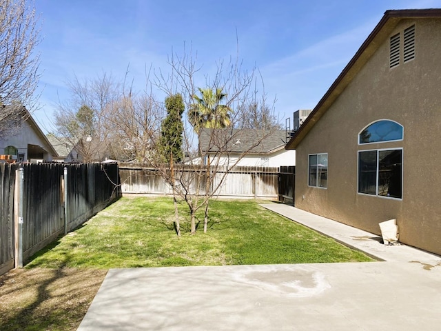 view of yard with a patio area and a fenced backyard