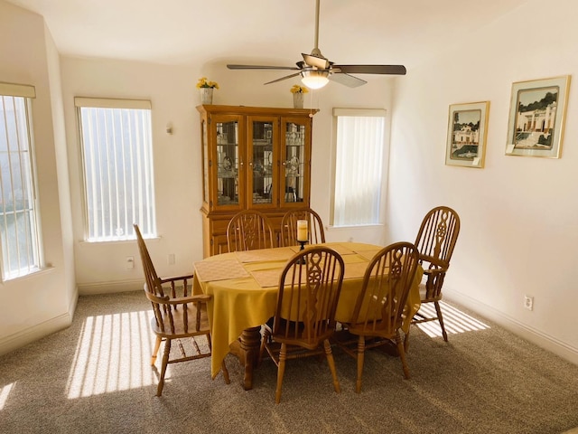 dining room featuring carpet, a ceiling fan, and baseboards