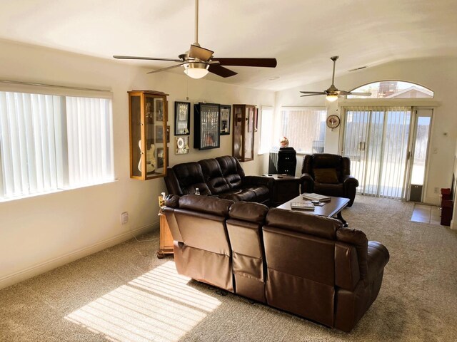 living room with carpet, baseboards, vaulted ceiling, and a ceiling fan