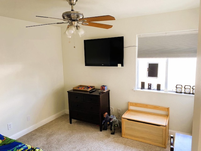 bedroom featuring light carpet, ceiling fan, and baseboards