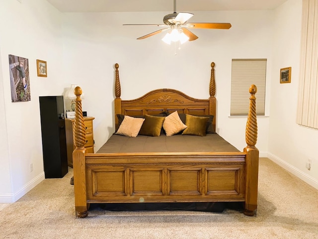 bedroom with light carpet, ceiling fan, and baseboards