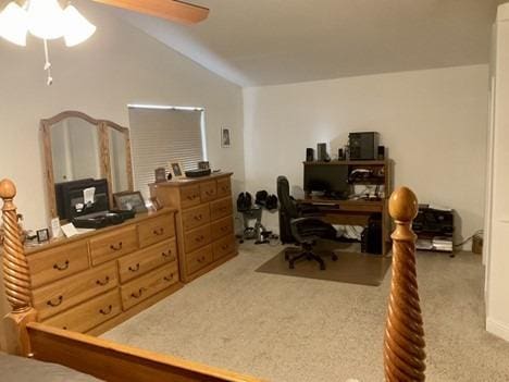 office area with vaulted ceiling, carpet, and a ceiling fan