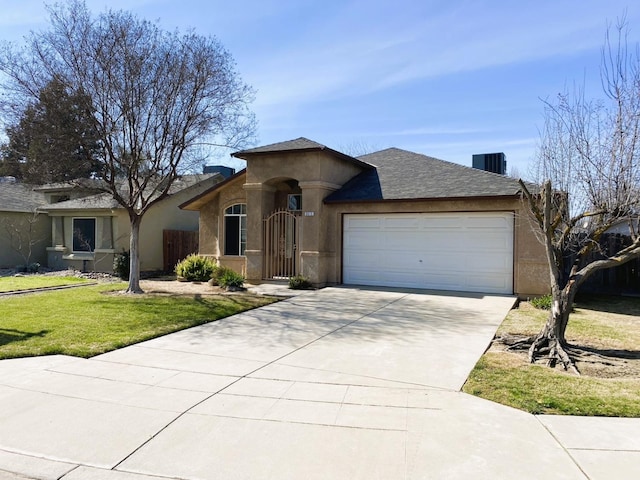 ranch-style house with a front yard, driveway, an attached garage, and stucco siding