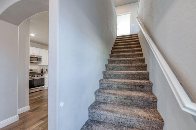 stairs with hardwood / wood-style floors