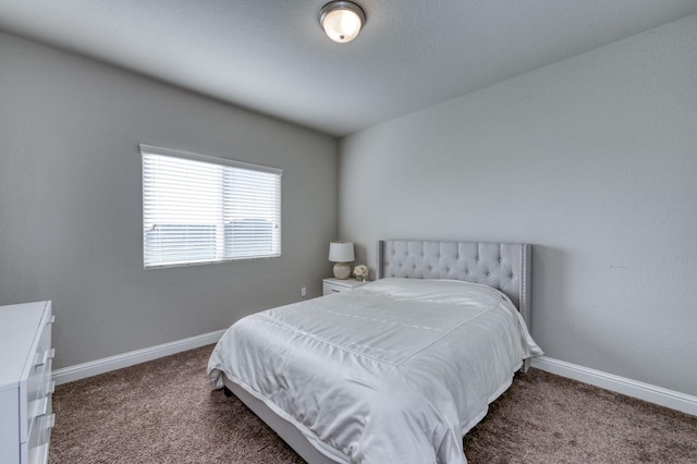 bedroom with dark carpet