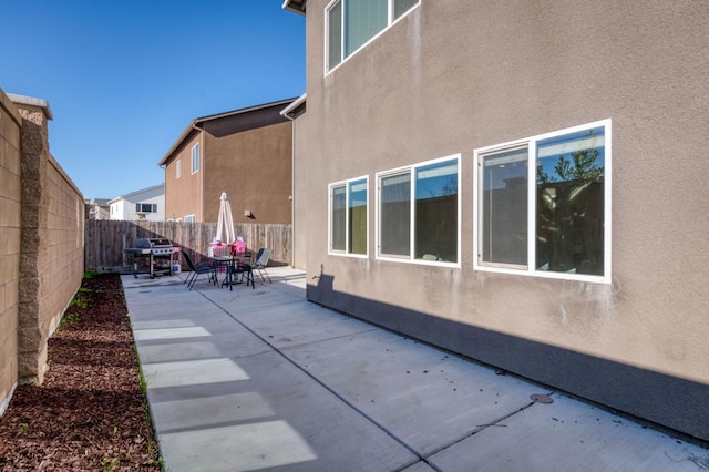 view of side of property with a patio area