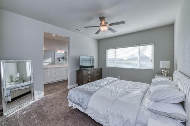 carpeted bedroom featuring sink, connected bathroom, and ceiling fan