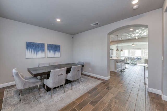 dining space with sink and ceiling fan