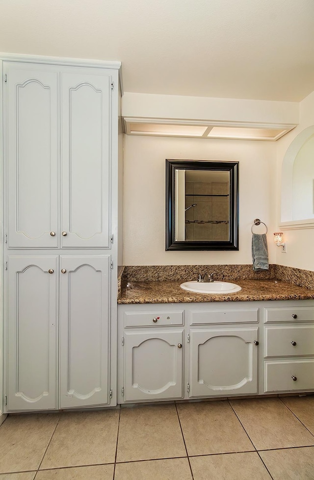 bathroom with tile patterned floors and vanity