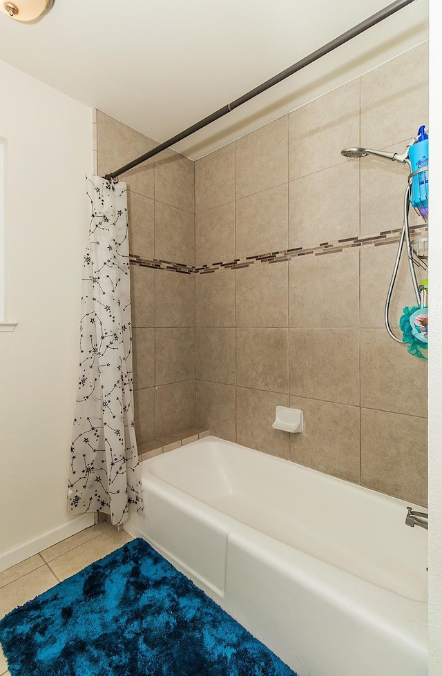 bathroom with shower / bath combination with curtain and tile patterned floors