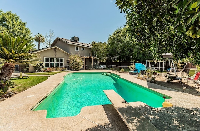 view of pool featuring central air condition unit, a diving board, and a patio