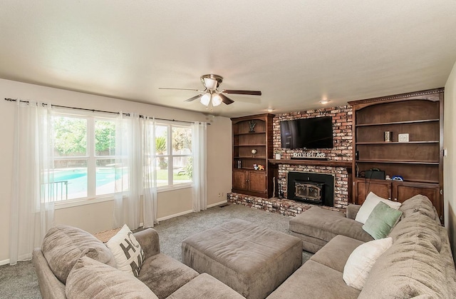 living room with ceiling fan, light carpet, and a wood stove