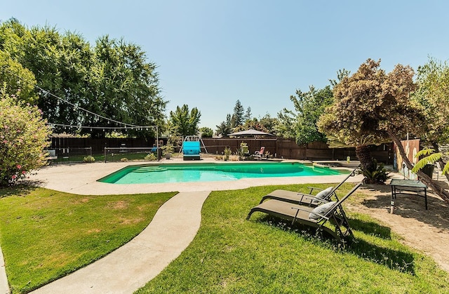 view of pool with a yard and a patio