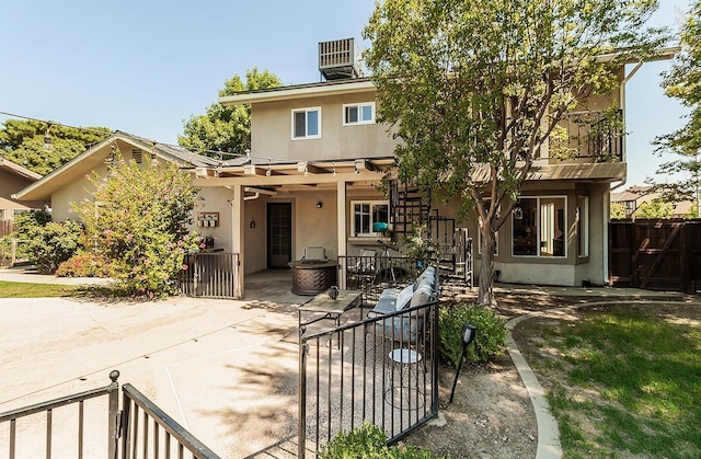 view of front of home featuring a patio and central AC