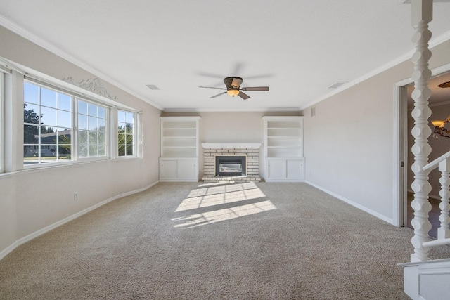 unfurnished living room featuring a brick fireplace, light carpet, ornamental molding, and ceiling fan