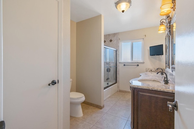 full bathroom with toilet, shower / bath combination with glass door, tile patterned floors, and vanity