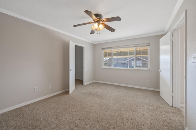 unfurnished bedroom featuring ornamental molding, light colored carpet, and ceiling fan