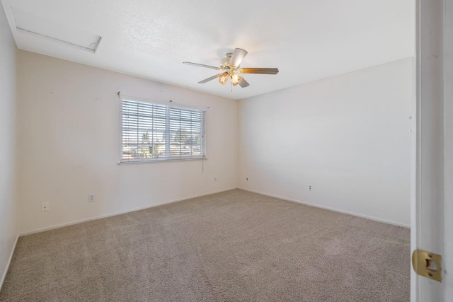 empty room featuring light colored carpet and ceiling fan