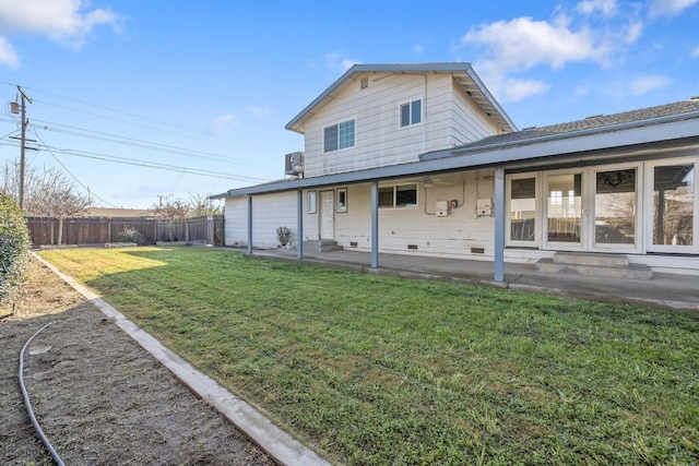 back of property with a patio and a lawn