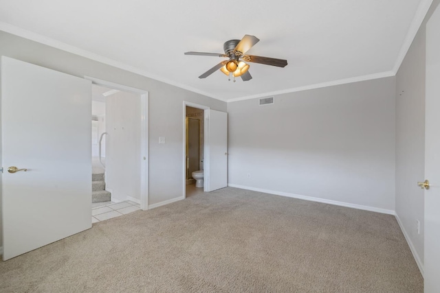 unfurnished bedroom with ensuite bath, ceiling fan, ornamental molding, and light carpet