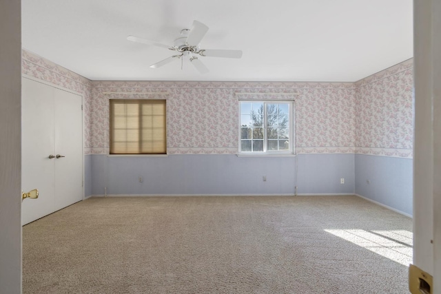 empty room with light colored carpet and ceiling fan