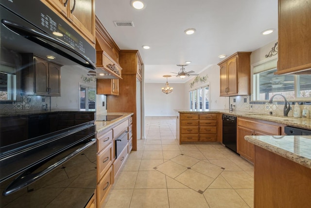 kitchen with sink, decorative light fixtures, ceiling fan with notable chandelier, backsplash, and black appliances