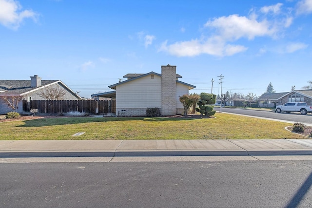 view of side of home with a yard