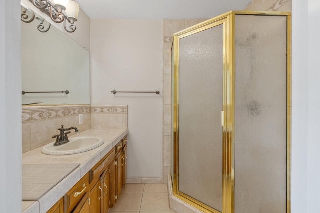 bathroom featuring decorative backsplash, tile patterned flooring, walk in shower, and vanity