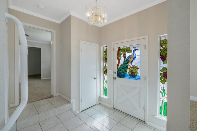 tiled entryway with an inviting chandelier and crown molding